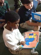 Kids read their new books.