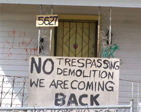 Sign Reading: No Trespassing, Demolition. We Are Coming Back.