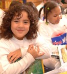 Smiling girl hugging her book
