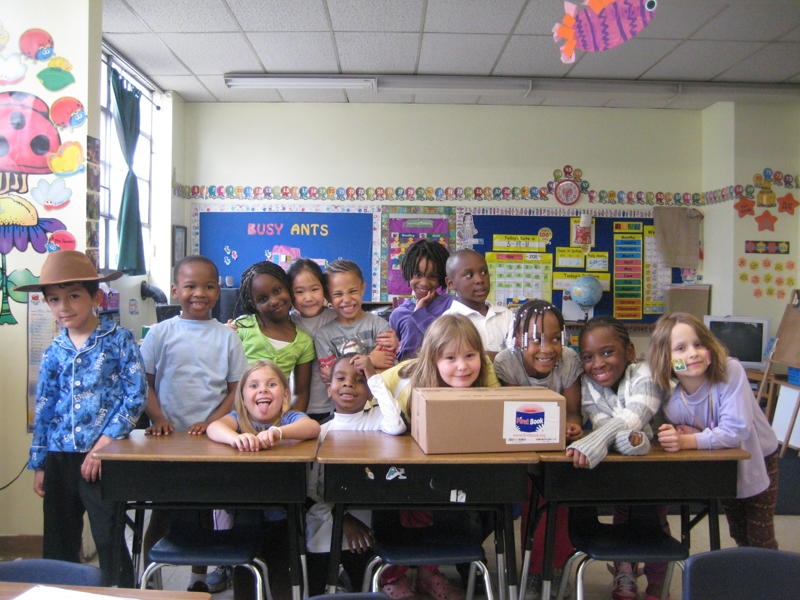Students at Pittsburgh Urban Christian School in Wilkinsburg, PA, celebrating their books from First Book
