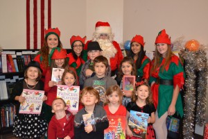 Students have breakfast with Santa and receive books provided by First Book 