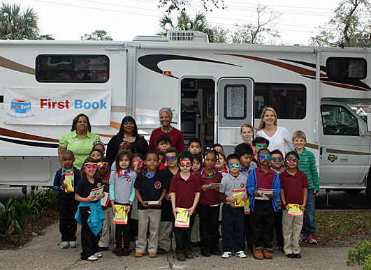 The Berg family and First Book volunteers with local children in New Orleans